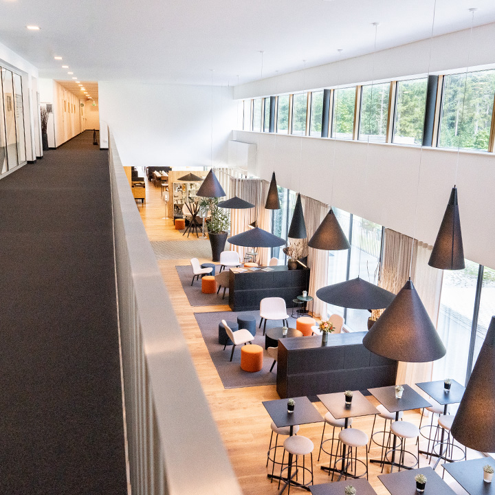 A modern hotel lobby featuring stylish furniture and elegant lighting.