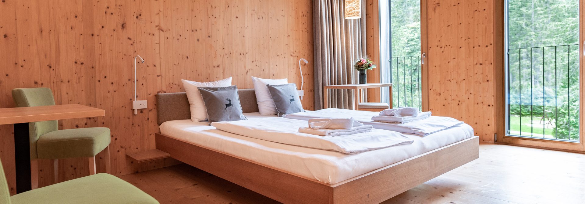 A modern wooden bedroom featuring a cozy bed and stylish furnishings.