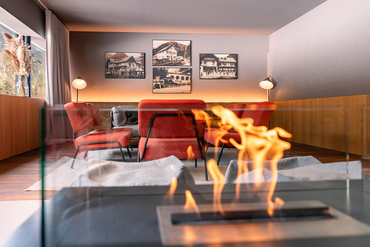 Modern living room featuring a fireplace and stylish red chairs.
