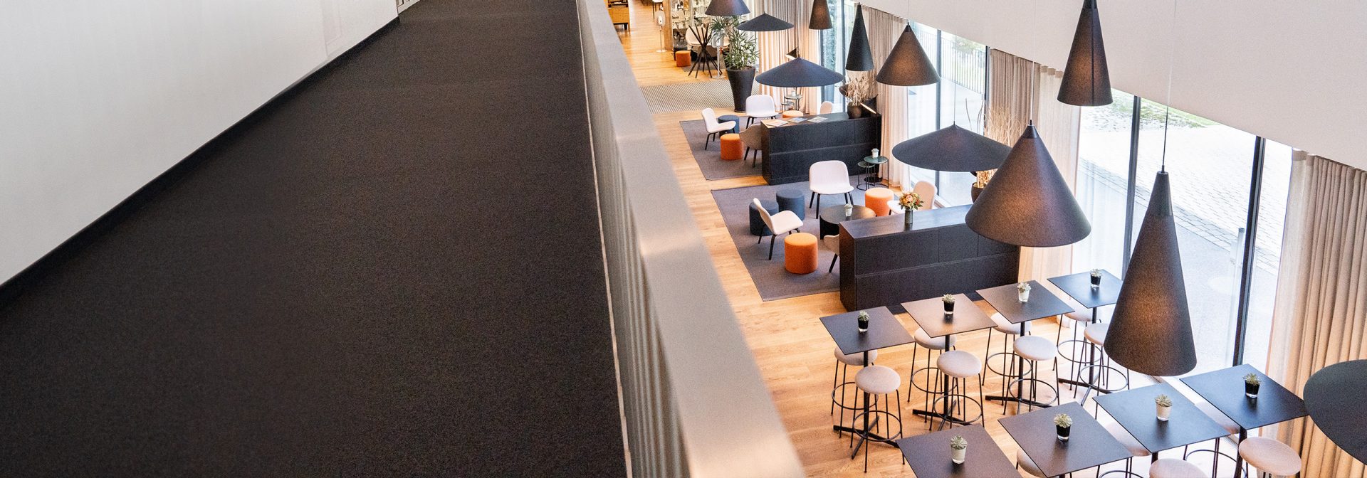 A modern hotel lobby featuring stylish furniture and elegant lighting.