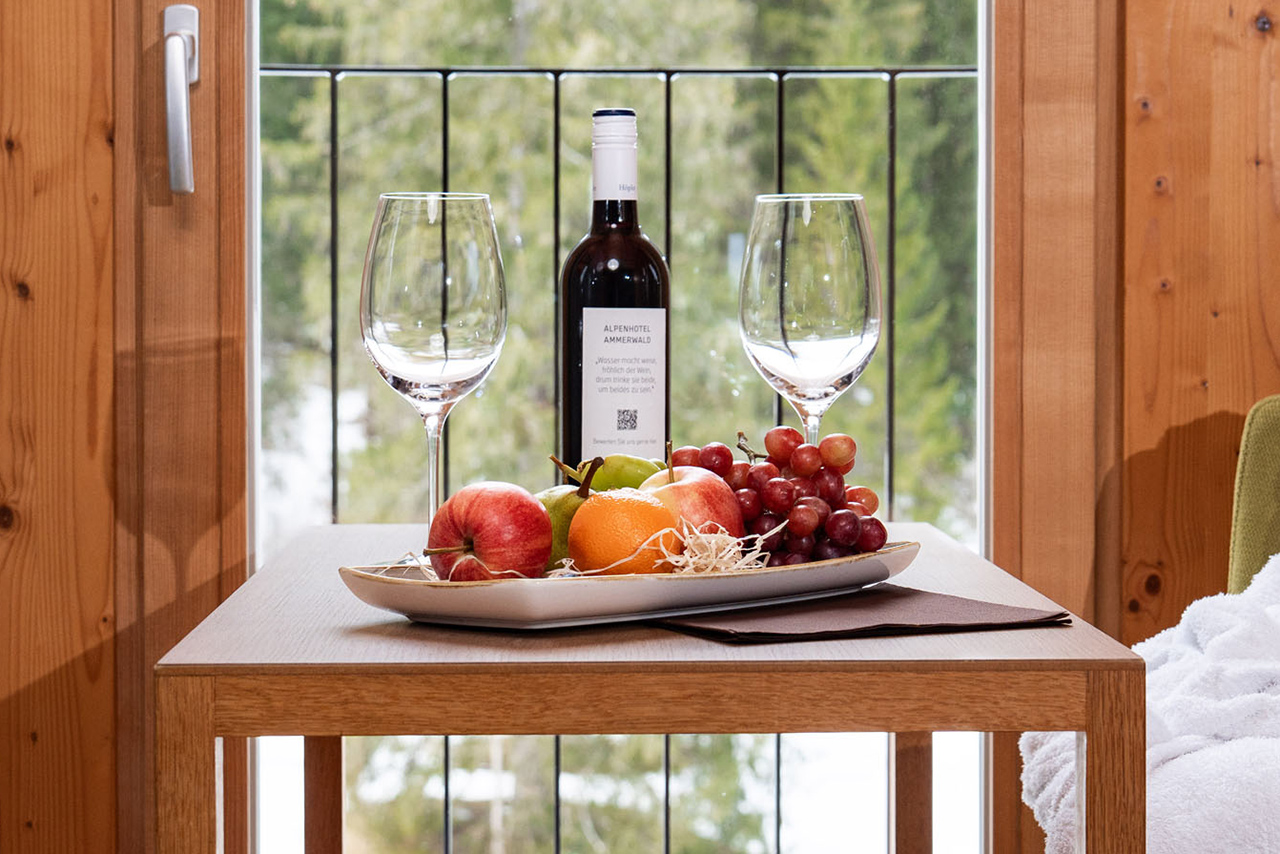 A table displaying a selection of fresh fruit and a wine bottle, enhancing the ambiance of the setting.