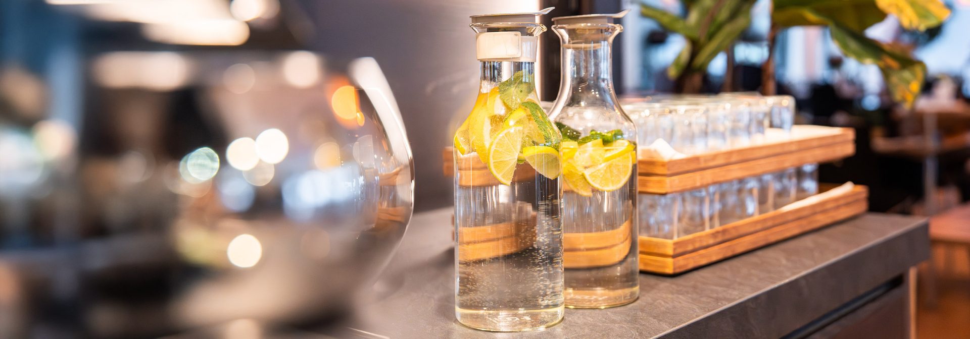 Two carafes filled with refreshing lemon water on a stylish table.
