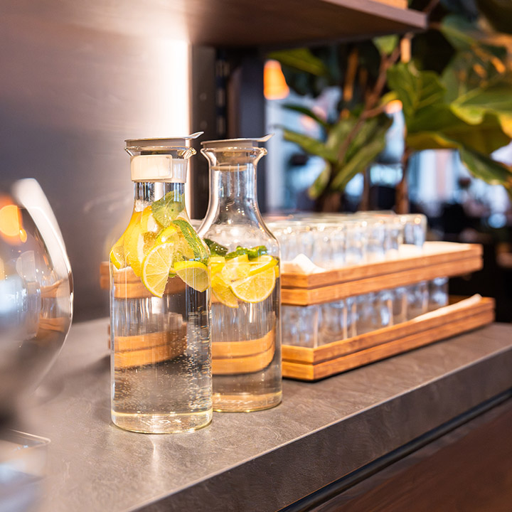 Two carafes filled with refreshing lemon water on a stylish table.