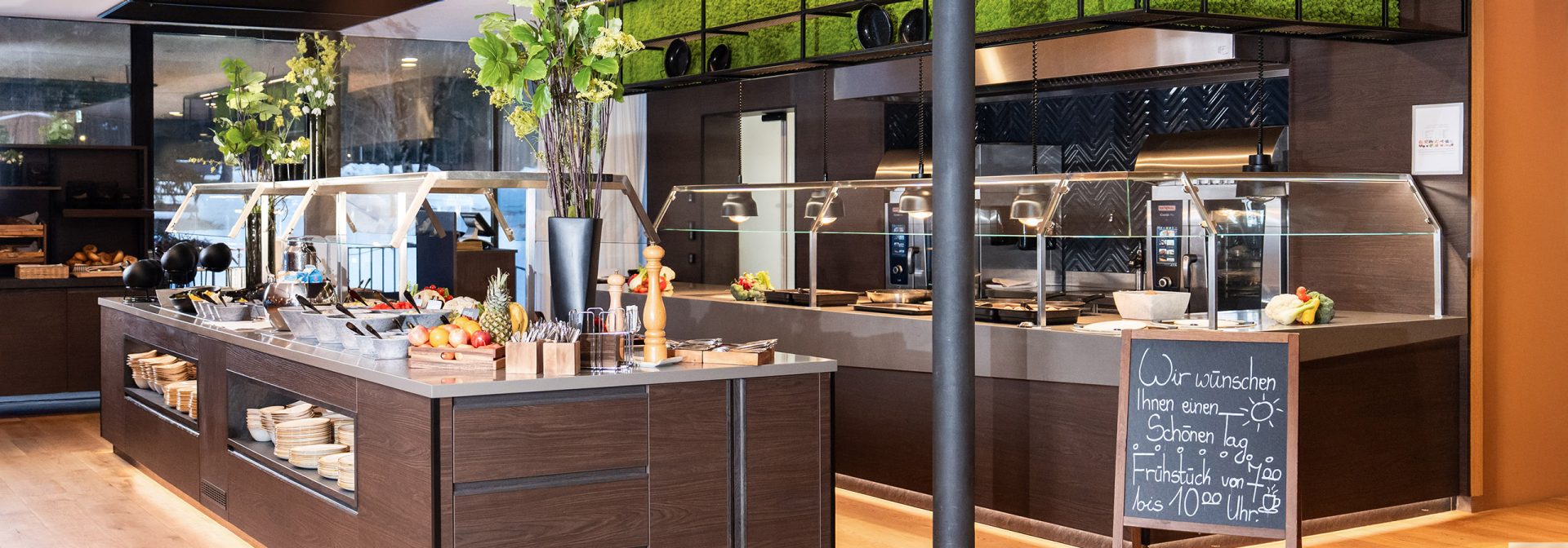 A modern kitchen buffet setup featuring fresh fruits and elegant decor.