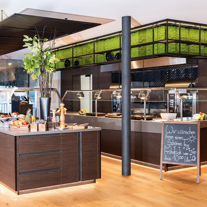 A modern kitchen buffet setup featuring fresh fruits and elegant decor.