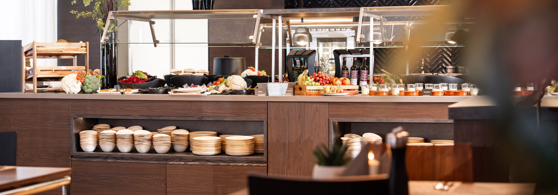 A variety of fresh vegetables and fruits displayed in a buffet setting.