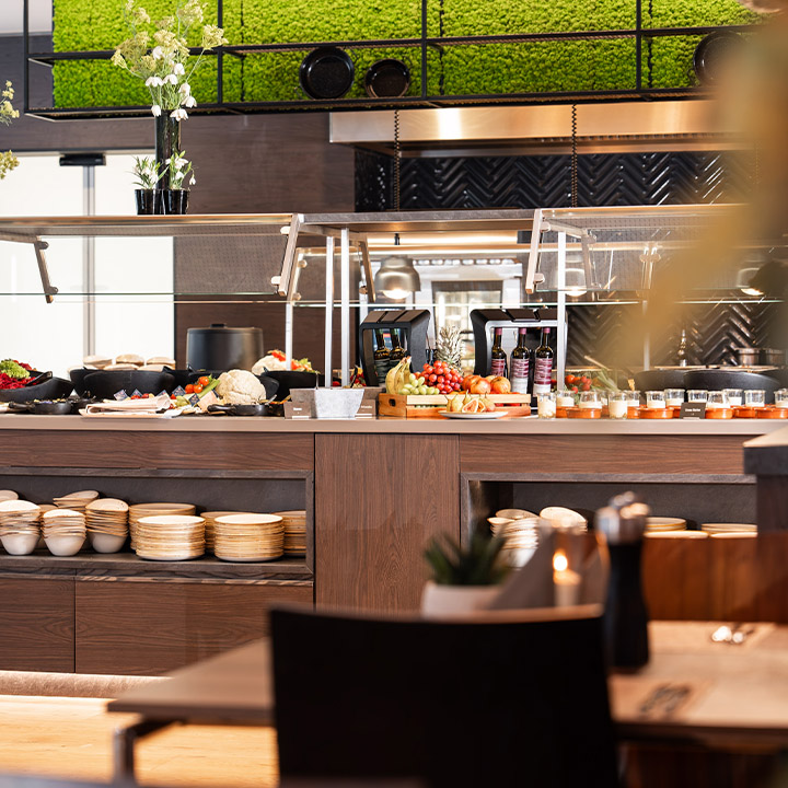 A variety of fresh vegetables and fruits displayed in a buffet setting.