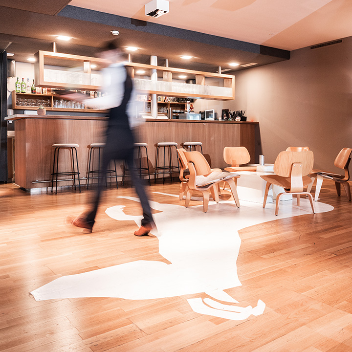  modern coffee shop interior featuring wooden furniture and a bar.