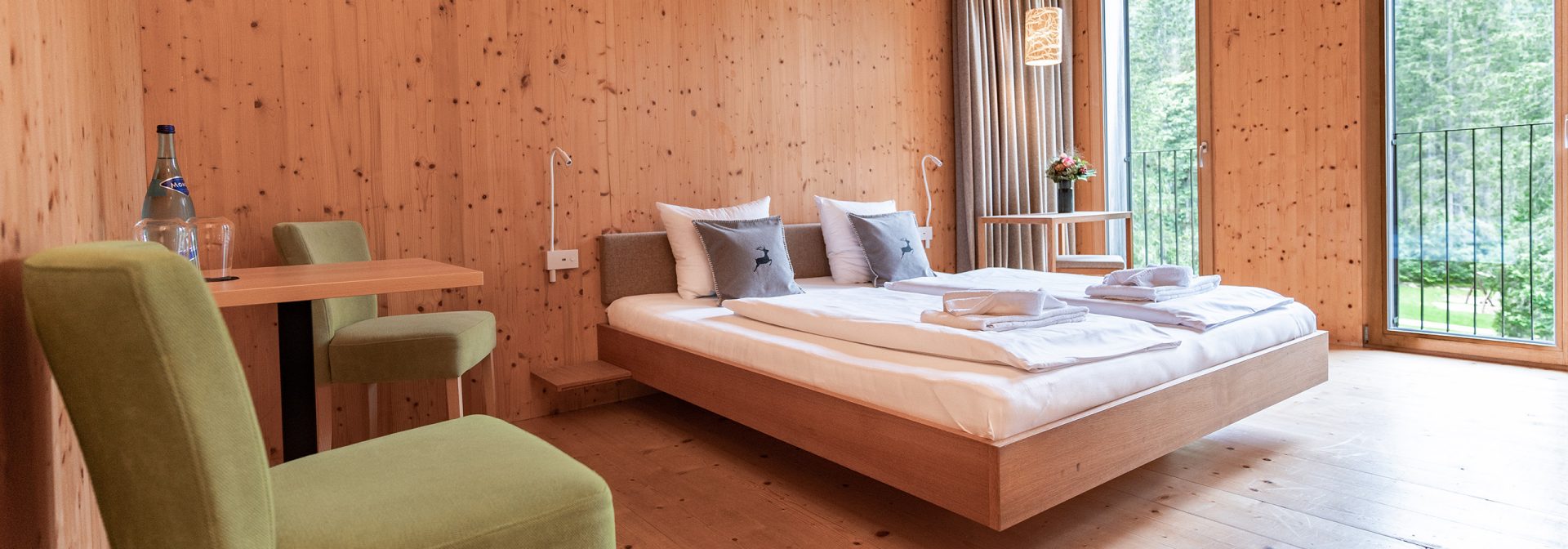 A modern wooden bedroom featuring a cozy bed and stylish furnishings.