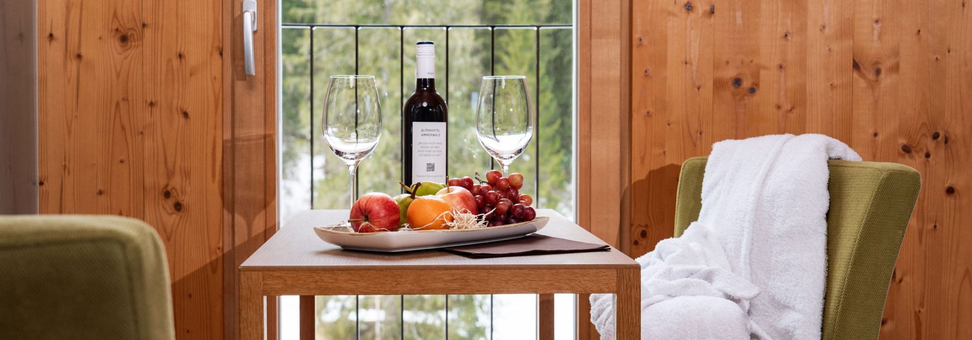 A table displaying a selection of fresh fruit and a wine bottle, enhancing the ambiance of the setting.