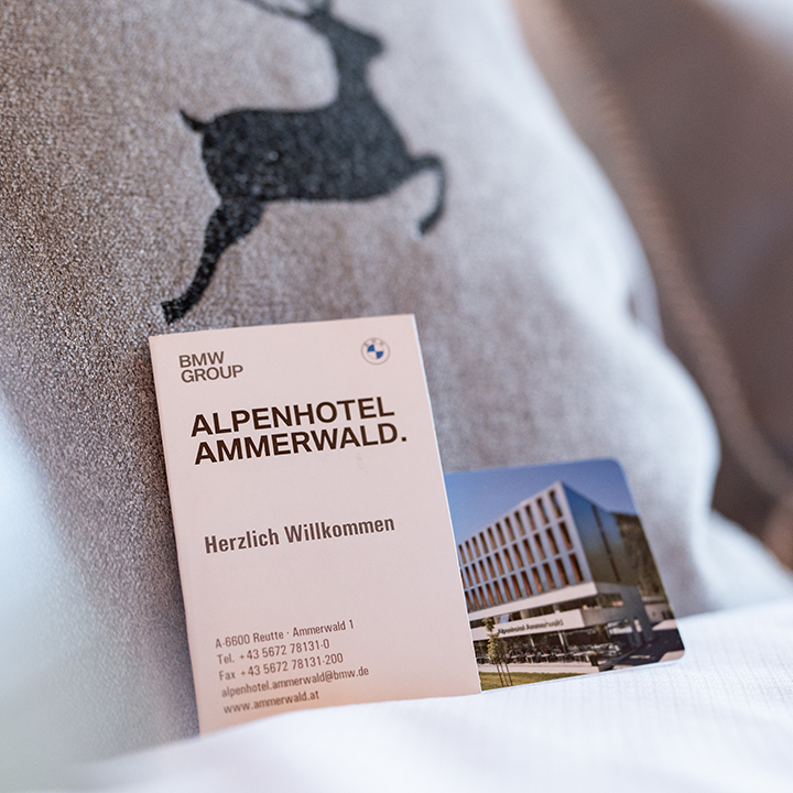 Key card for Alpenhotel Ammerwald with welcome message.