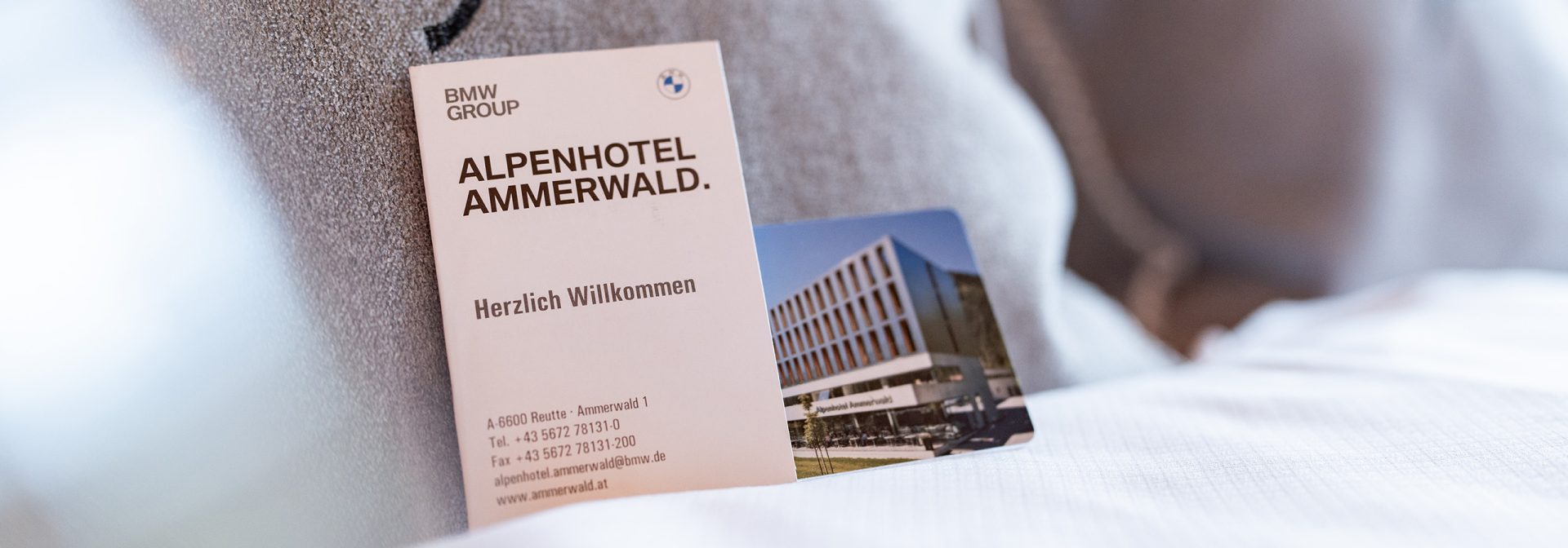 Key card for Alpenhotel Ammerwald with welcome message.