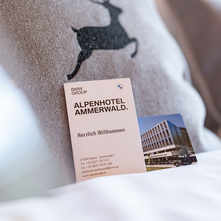 Key card for Alpenhotel Ammerwald with welcome message.